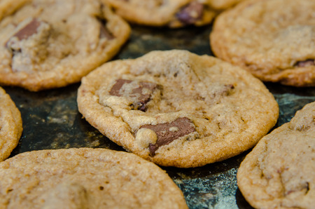 A close up of a chocolate chunk cookie cooling on a granite countertop