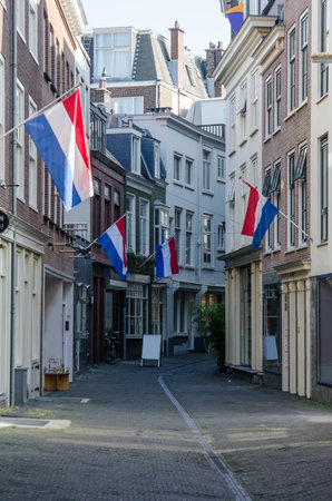 The day after the government opens in The Hague, Netherlands, Dutch flags hang along a quiet city streetのeditorial素材