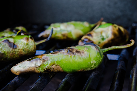 Green peppers roasting on the grillの写真素材