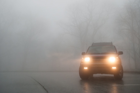 A red SUV sits in thick fog in a pullout along the Blue Ridge Parkwayの写真素材