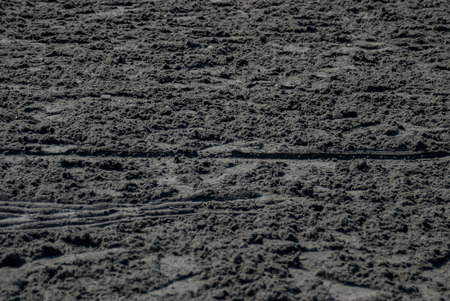 Unraked dirt at a horse racing trackの写真素材
