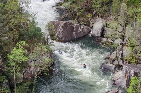 Kayakers paddle over rapids below Toccoa Fallsの写真素材
