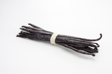 A bunch of vanilla beans tied with twine isolated on whiteの写真素材