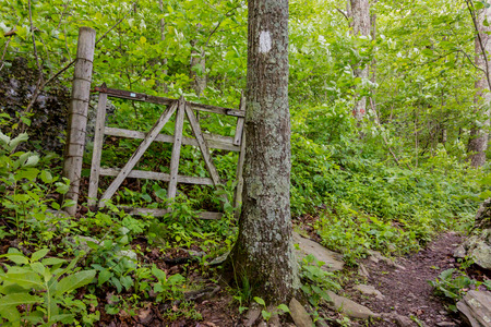The Appalachian trail passes an old gated area likely used for farming or agricultureの写真素材