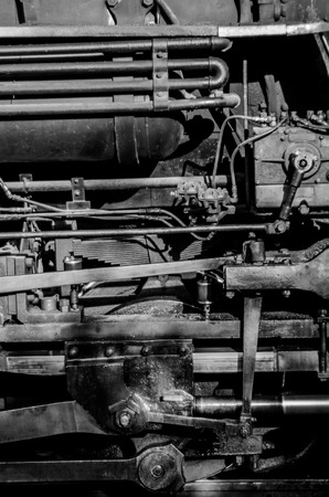 A close up of a train engine in black and white