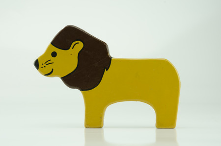 A painted wooden lion toy on whiteの写真素材