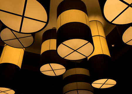 Tub Chandeliers Hang from Ceiling in an urban buildingの写真素材