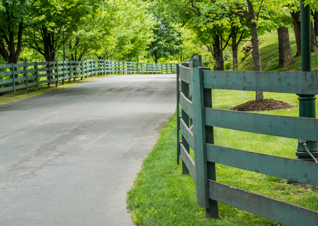Green Fence Lining the Road to a Kentucky distilleryの写真素材