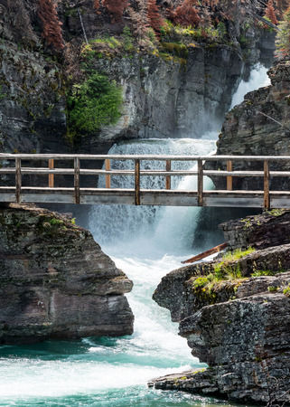 Saint Mary Falls and Bridge in Montana mountainsの写真素材