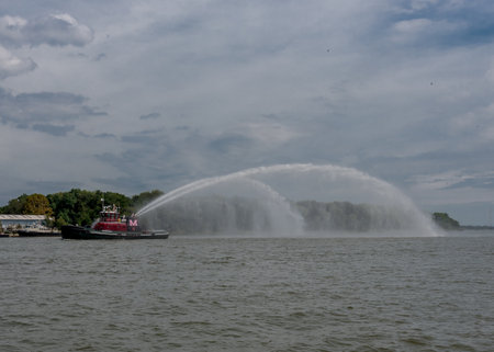 October 2, 2016: A fire boat sprays water while cruising the Savannah Riverのeditorial素材