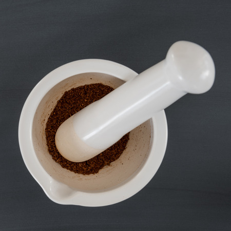 Mortar and Pestle with Spices on chalkboard backgroundの写真素材