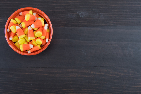 Orange Bowl of Candy Corn on Dark Wooden Background