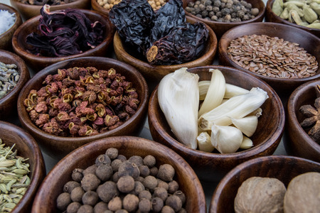 Bowl of Garlic Among Spices in wooden bowls