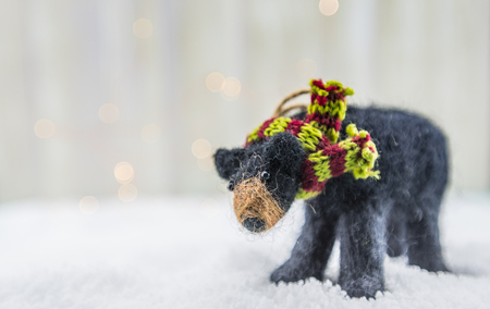 Felt Bear Ornament Side View with Copy Space to Left over white bokehの写真素材