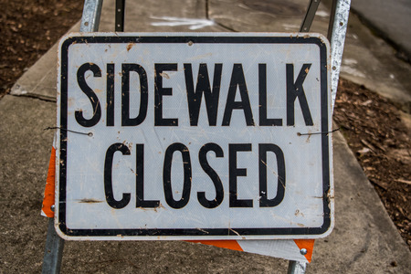 Sidewalk Closed Sign Fills Frame in construction zoneの写真素材