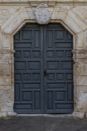 Front Door to Old Spanish Mission through stone wallの写真素材