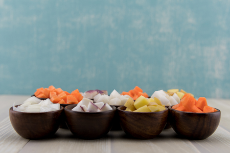 Root Vegetables in Small Bowls on table topの写真素材