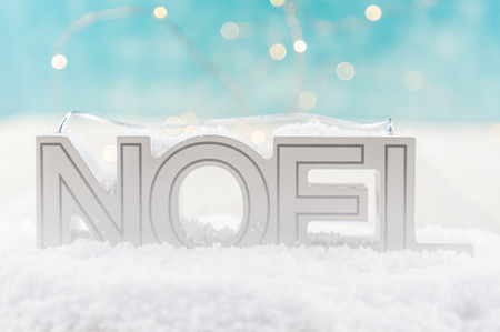 NOEL in Snow with blue and white bokeh backgroundの写真素材