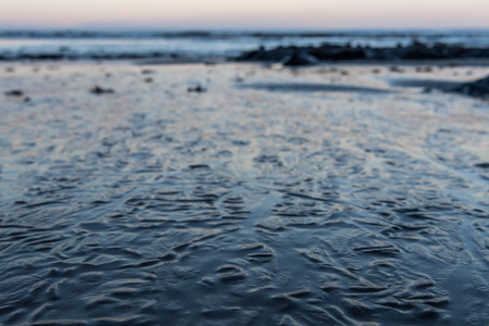Wrinkles in Sandy Surface  from Receding Tide