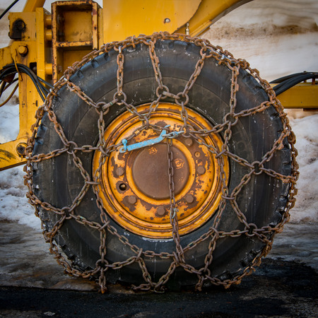 Snow Chains on Large Tire on Snow Plowの写真素材