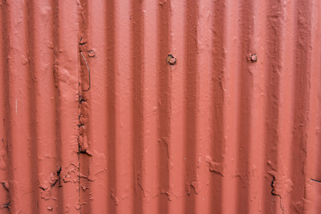 Corrugated Steel Wall with Thick Orange Paintの写真素材