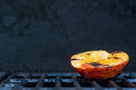 Single Grilled Peach on Right With Copy Space over grillsの写真素材
