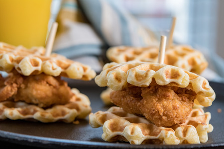 Three Chicken and Waffle Sliders on cast iron skillet backgroundの写真素材