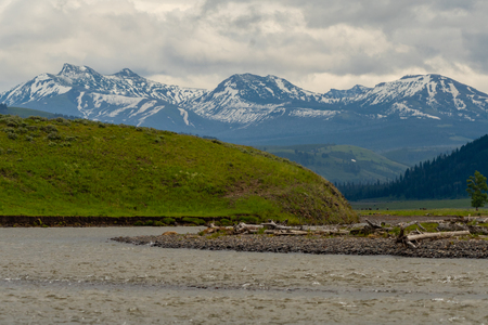 Sun Breaks Through Cloudy Day Over Lamar River in Yellowstoneの写真素材