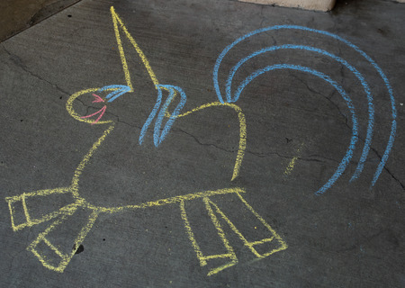 Chalk Outline of Unicorn on Sidewalk in city areaの写真素材