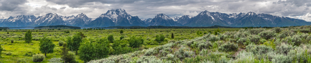 Wide Panorama of Tetons Behind Marshy Plains on stormy dayの写真素材