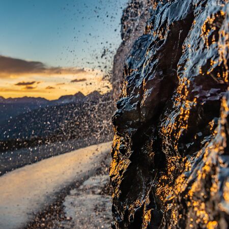 Sunlight Reflects off Waterfall Along Cliff Edge
