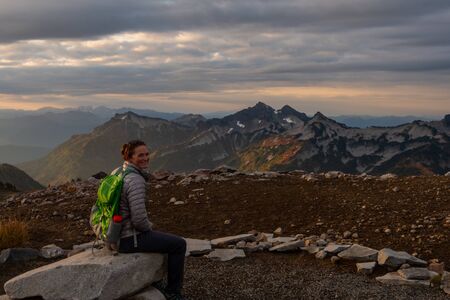Woman Looks Back at Camera at Overlook of Tatoosh Range