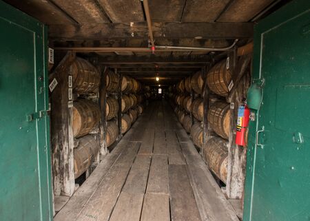 Barrels in Storage Building at Distillery with green doors