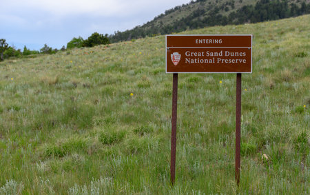Great Sand Dunes National Preserve Sign in Grassy Field in summerのeditorial素材