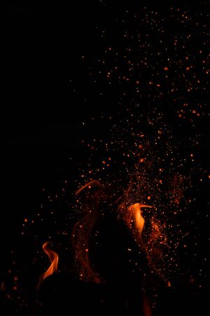 Faint Flames and Embers against black night sky