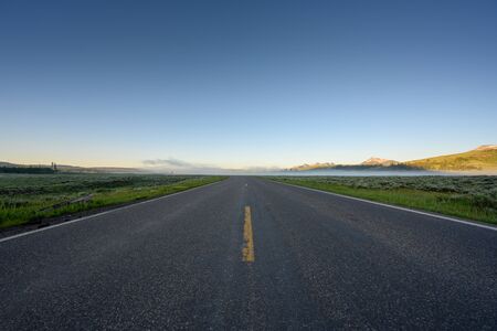 Low Angle of Road through Yellowstone Wilderness in early summer morning