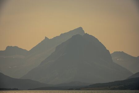 Grinnell Point In Summer Haze across from Montana lake