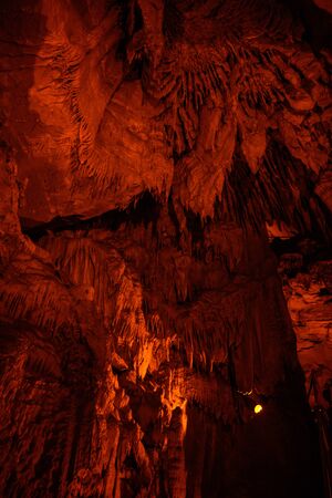 Frozen Niagra formation glows with orange light inside Mammoth Caveの写真素材