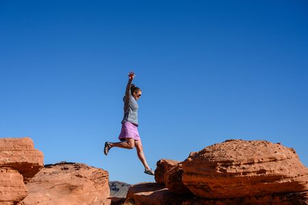 Woman In Mid Air As She Rock Hops