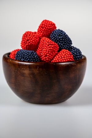 Wooden bowl with sprinkle covered candyの写真素材