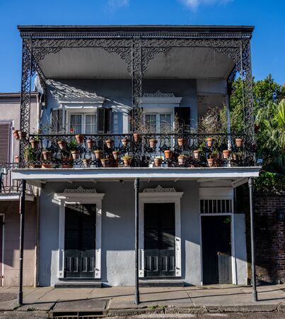 Flower Pots Hang from Balcony with wrought iron detailの写真素材