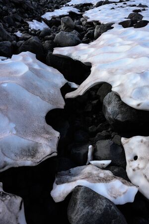 Snow Melts Through to Rocks in Summerの写真素材