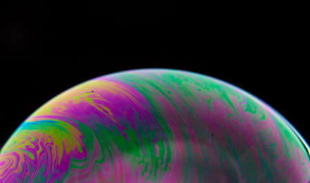 Brilliant Pink and Green Streaks on Bubble with dark backgroundの写真素材