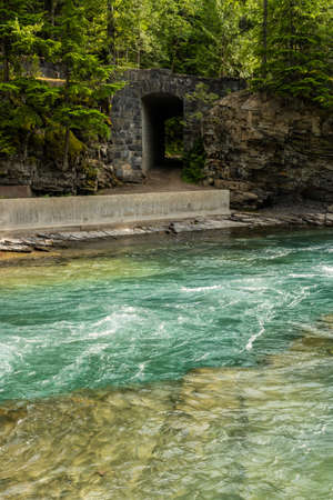 Creek Flowing Past Horse Tunnel in Glacierの写真素材