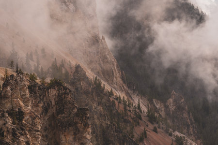 Fog Clings to Cliffs of Grand Canyon Of The Yellowstone in summerの写真素材