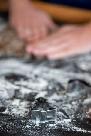 Christmas Tree Cookie Cutter Waits on Floured Surface While Dough is Pressedの写真素材
