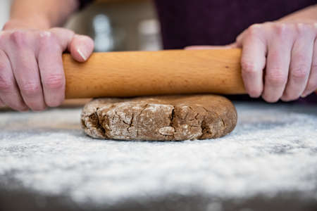 Firm Gingerbread Dough Getting Rolled into Cookies during a holiday baking sessionの写真素材