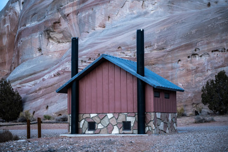 Pit Toilet At White House Campground In Southern Utah in front of tall rock wall