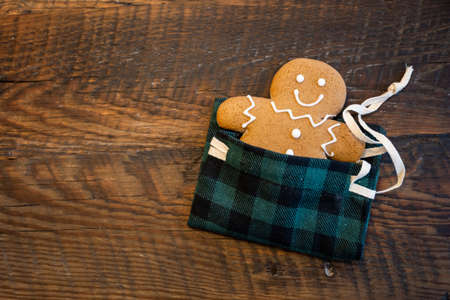 Gingerbred Man Tucked into Plaid Sleeping Bag with Ribbonの写真素材
