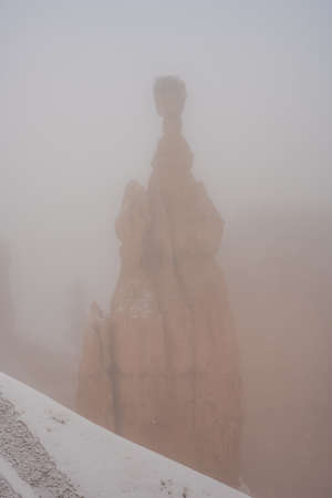 Thors Hammer Stands Obstructed In Snowy Fog in Bryce canyon National Parkの写真素材